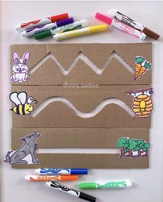 cardboard board with stickers and crayons on it