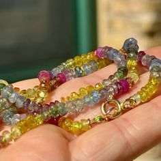 This rainbow necklace combines a vibrant array of Ruby, Sapphire, and Diopside gemstones. Its vibrant colors are perfect for lovers of bright colors and good vibes. Wear it as reminder or brighter things to come or as a symbol of your own inner radiance.  It's 18" long and knotted by hand on a custom-dyed lime green silk cord and finished with 14/20 gold filled findings and an 7mm spring ring clasp perfect for hanging charms, lockets, or talismans. . This necklace is a limited edition, and while Multicolor Fusion Necklace For Gift, Multicolor Fusion Necklaces For Gifts, Rainbow Round Beads Gemstones For Gift, Colorful Gemstone Beads Necklace For Gift, Vibrant Rainbow Necklace For Gift, Spiritual Multicolor Faceted Necklace, Colorful Gemstone Necklaces For Gifts, Colorful Gemstone Bead Jewelry, Multicolor Gemstone Beads For Gift