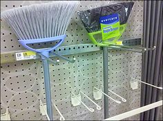 two brooms are on display in a store