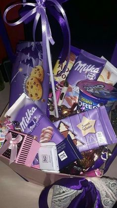 a basket filled with lots of different types of candy and cookies on top of a table