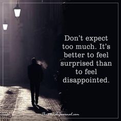 a person walking down a street at night with the words don't expect too much it's better to feel surprised than to feel disappointed