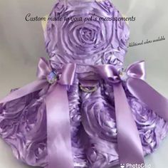 a teddy bear dressed in purple and wearing a dress made out of satin material with roses on it