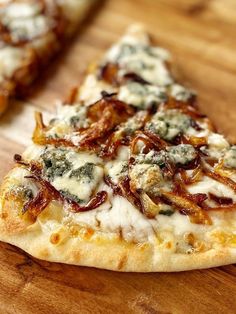 two slices of pizza sitting on top of a wooden cutting board