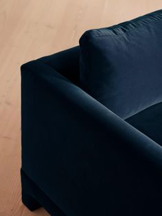 a blue couch sitting on top of a wooden floor