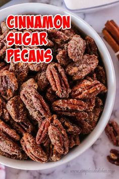 cinnamon sugar pecans in a white bowl on a marble counter top with the words, cinnamon sugar pecans