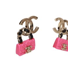 These funky Chanel earrings feature a dangling pink resin classic quilted flap bag with a black leather and gold tone handle on a signature gold tone CC pierced ear clip. Collection: 23SOrigin: Italy Condition: New and never wornAccompanied by: Chanel boxMeasurements: 1.5" width x 1" height Cc Earrings, Chanel Pink, Pierced Ear, Classic Flap Bag, Pink Chanel, Chanel Earrings, Leather Detail, Bag Design, Dangling Earrings