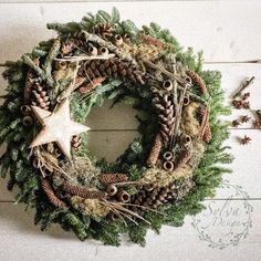 a christmas wreath with pine cones and other decorations