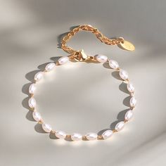 Elevate your wrist wear with our Elegant Oval Pearl Bracelet, a sophisticated piece that captures the essence of timeless elegance. This bracelet features lustrous oval-shaped pearls strung together with delicate craftsmanship, perfect for adding a touch of classic beauty to any attire. Key Features: - Oval Pearls: Exquisitely selected for their shape and radiance, each pearl brings a touch of sophistication. - Durable Clasp: Secured with a high-quality clasp for easy wear and lasting use. - - Versatile Style: The bracelet's simple yet elegant design complements both casual and formal looks. - Perfect Gift: Beautifully presented, it's an ideal gift for anniversaries, birthdays, or a special treat for yourself. Ordering Process: Select your preferred bracelet size, add to cart, and proceed Elegant Metal Chain Bracelet With Pearl, Elegant Pearl Chain Bracelet With Pearl Drop, Elegant Adjustable Pearl Chain Bracelet, Elegant White Chain Bracelet With Pearl Drop, Classic White Pearl Chain Bracelet, Elegant Metal Bracelets With Pearl Chain, Elegant Metal Bracelet With Pearl Chain, Elegant Adjustable Chain Bracelet With Pearl Charm, Elegant Adjustable Pearl Charm Chain Bracelet