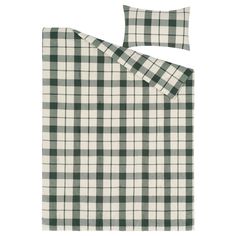 a green and white checkered bed spread with two pillow cases on top of it