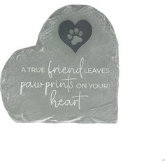 a stone with a paw print on it and a heart shaped pet memorial in the center