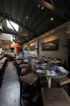 an empty restaurant with tables and stools