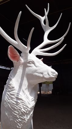 a white sculpture of a deer with antlers on it's head