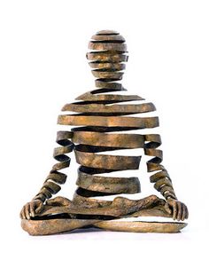 a statue sitting in the middle of a yoga pose with many lines on it's body