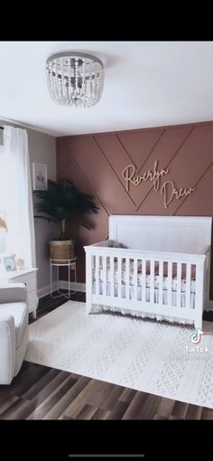 a baby's room with a white crib and brown walls