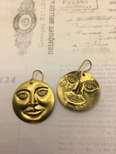 "Brass man in the moon face dangle earrings. 1 1/4\" round. They dangle 1 1/2\" long. These are vintage 1970's brass charms. They have never been used until now. Vintage quality and made to last a lifetime. Last photo shows a popular locket in my shop made with this same brass stamping. I offer quick shipping and all packages arrive ready for gift giving. free domestic shipping! I also offer low international shipping rates because I love my international customers! Here is the link to my shop: Vintage Moon-shaped Earrings For Gift, Vintage Moon Shaped Earrings For Gift, Vintage Moon Earrings For Gift, Vintage Moon Shaped Earrings, Vintage Moon Earrings, Man In The Moon Face, Moon Face Earrings, Handwritten Gifts, Man In The Moon