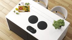 an overhead view of a kitchen table with potted plant on it and cutting board