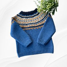 a blue sweater with a plant in it