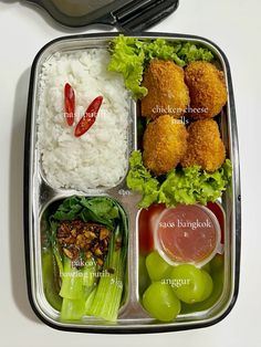 a bento box filled with rice, meat and veggies