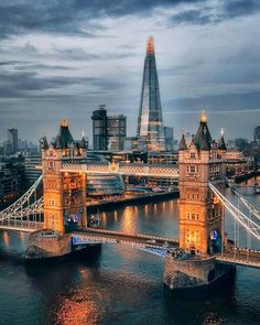 an aerial view of the london bridge and shardling building in the background at dusk