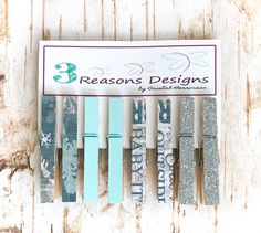 four pens are lined up next to each other in front of a sign that says 3 reason designs