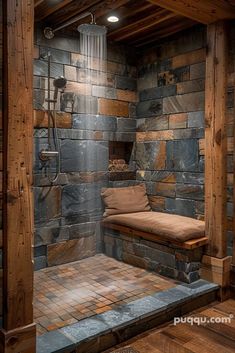 a rustic bathroom with stone walls and wood flooring, including a shower head in the corner