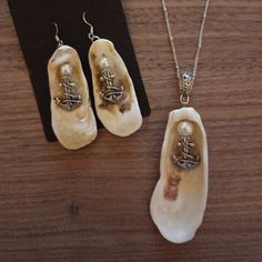 two pieces of jewelry sitting on top of a wooden table