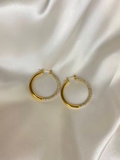 These sparkly gold CZ hoops will make you sparkly all night. A great accessory for the girl who loves to stand out and show off her style, these hoops will make sure you turn heads! Just remember: you're the one who's that girl! -18k gold plated -waterproof/ safe to be worn in water -packaged in a box/pouch (gift ready) Sparkly Gold Hoop Earrings, Sparkling Stones Hoop Earrings, Gold Hoop Earrings With Sparkling Stones For Gift, Gold Bling Hoop Jewelry, Gold Rhinestone Hoop Earrings, Gold Hoop Jewelry With Bling, Gold Sparkling Hoop Earrings, Glamorous Gold Hoop Earrings With Bling, Trendy Sparkling Gold Jewelry