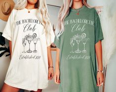 two women standing next to each other wearing matching t - shirts that read the bachelor club