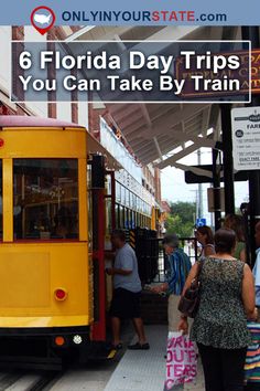 a yellow and red trolley at a train station with people standing on the platform next to it