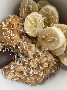 a bowl filled with oatmeal, bananas and peanut butter