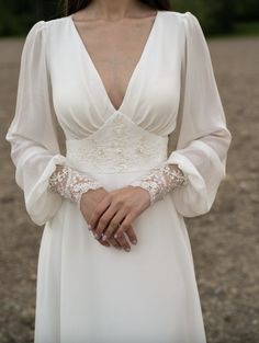 a woman in a white dress is posing for the camera with her hands on her hips