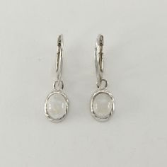 These is a beautiful pair of Sterling Silver Earrings with a Rainbow Moonstone Gemstone. The earrings are made out of solid 925 Silver and there is no nickel or other substances causing most allergies. This makes the earrings hypo allergenic. Size of one Earring in total 4.0 x 1.2 cm or  1.57 x 0.47 inch The hooks are 1.80 cm - or about 3/4 inch - in length. You will receive the item in a gift box - perfect to surprise someone or yourself. Usually we ship on the same day we receive the payment f White Sterling Silver Oval Earrings, Adjustable Oval Sterling Silver Earrings, White Oval Sterling Silver Earrings, Silver Oval Earrings With Lever Back Ear Wires, Silver Oval Pendant Earrings For Anniversary, Silver Oval Earrings With Ear Wire, Sterling Silver Oval Pendant Earrings In Silver, Adjustable Silver Oval Earrings, Labradorite Earrings