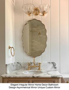 an elegant bathroom with marble counter tops and gold faucet lights on the wall