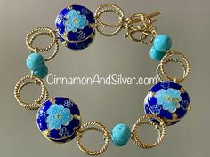 Blue Cloisonné and gemstone beaded bracelet adds a beautiful pop of summer boho color! Dark cobalt blue and bright turquoise colors are highlighted by metallic gold tones, with a fun circle and floral vintage boho motif! Bracelet is handmade from  twisted gold tone wire connecting rings, turquoise-dyed Howlite gemstone crystal beads, and cloisonné enamel coin beads.   Bracelet measures 8" long, but fits at 7.5" due to bead size. Can be lengthened by request. Closes with toggle clasp. Lead-free and nickel-free. Largest cloisonné bead is 1" diameter. Turquoise blue-dyed Howlite gemstone beads are 8mm. Cloisonné is an ancient enameling technique for decorating metalwork objects, with colored-glass paste placed within enclosures made of copper or bronze wires, which have been bent or hammered Blue Bangle Jewelry With Large Beads, Bohemian Blue Bracelets With Spacer Beads, Blue Bohemian Bracelets With Spacer Beads, Bohemian Blue Polished Beads Bracelet, Artisan Blue Bangle Bracelet, Artisan Blue Bangle Bracelets, Blue Bohemian Bracelets With Polished Beads, Nickel-free Blue Bohemian Beaded Bracelets, Nickel Free Blue Bohemian Beaded Bracelets