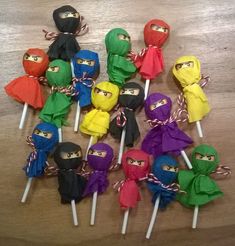 many different colored lollipops with ninja masks on them sitting on a table