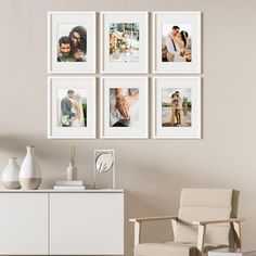 a living room with white furniture and pictures on the wall