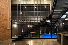 an indoor swimming pool in the middle of a building with stairs leading up to it