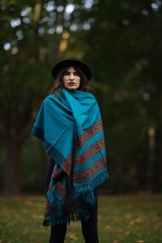 Discover the charm of our beautiful scarf with ethnic patterns and symbols! This cozy and versatile accessory can be worn as a stole, scarf, blanket, or decoration.  Crafted from luxuriously soft wool (50%) and viscose (50 it provides warmth and features vibrant colors and fascinating patterns that elevate any outfit. Unisex and adorned with fringes, this scarf is the perfect companion in chilly weather.  Measuring 100 cm in width and 210 cm in length (excluding fringes), it offers diverse styling possibilities. Available in 5 colors/patterns (Red, Dark Red, Turquoise, Dark Blue, Beige) and sourced on a Fair Trade basis, this accessory is not only stylish but also ethically conscious.  Surprise your loved ones with the perfect Christmas gift! ※ ---›Dimensions‹---  Width: 100 cm Length: 210 Traditional Winter Silk Shawl Scarf, Blue Bohemian Handwoven Shawl, Bohemian Style One Size Scarf Wrap, Bohemian One Size Scarf Wrap, Bohemian Silk Scarf, Folk Style Handwoven Shawl, Handwoven Folk Shawl One Size, Bohemian Handwoven Shawl One Size, Handmade Folk Shawl For Winter