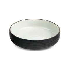 a black and white bowl on a white background with the rim slightly tilted to the side