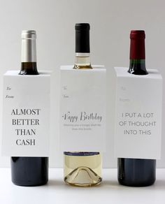 three bottles of wine sitting next to each other on top of a white countertop