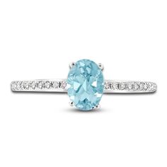 an oval aqua blue topazte and diamond ring with white diamonds on the band