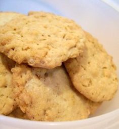 three cookies in a white bowl on a table