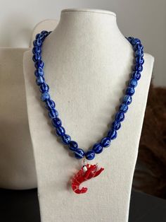 Necklace made of navy blue painted ceramic beads with a red blown glass lobster. Stainless steel clasp. Mismatched Jewelry, Ceramic Beads, Blue Paint, Charm Necklaces, Blown Glass, Glass Blowing, Charm Necklace, Spain, Jewelry Necklaces