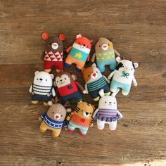 small crocheted stuffed animals sitting on top of a wooden table