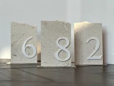 three blocks with the number six and eight on them are sitting in front of each other