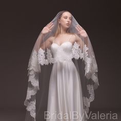 a woman wearing a wedding veil and dress