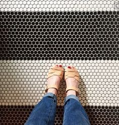 a person standing in front of a metal grate