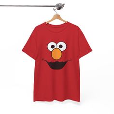 This Elmo Sesame Street T-shirt brings a fun and nostalgic vibe to any wardrobe. Perfect for fans of Sesame Street, this tee is great for casual wear or as a statement piece. Ideal for children's birthday parties, cosplay events, or everyday wear for fans of the beloved character. Product features - Shoulder tape for stability and prevent stretching - Made from specially spun fibers for smooth fabric perfect for printing - Ribbed knit collar for elasticity and shape retention - Ethically sourced Elmo Sesame Street, Sesame Street, Kids Birthday Party, Cute Cartoon, Gifts For Kids, Gender Neutral, Bathing Beauties, Adult Outfits, Tops & Tees