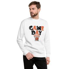 Get ready to dominate the court and show off your team spirit with this vibrant "Game Day" sweatshirt! This bold and energetic design features the phrase "GAME DAY" in dynamic black and orange letters with basketball-inspired patterns. Completing the look is a basketball perfectly sinking into the net, symbolizing the thrill of the game. This product is made especially for you as soon as you place an order, which is why it takes us a bit longer to deliver it to you. Making products on demand instead of in bulk helps reduce overproduction, so thank you for making thoughtful purchasing decisions! Orange Sporty Sweatshirt With Graphic Print, Sporty Orange Sweatshirt With Graphic Print, Orange Graphic Print Sporty Sweatshirt, Sporty Orange Sweatshirt With Letter Print, Long Sleeve Basketball Sweatshirt For Sports Season, Long Sleeve Basketball Sweatshirt, Basketball Cotton Sweatshirt For Sports Season, Cotton Sweatshirt For Basketball Sports Season, Game Day Sweatshirt