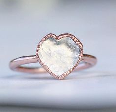 A sweet little heart shaped crystal quartz stone is electroformed with pure copper, creating a unique and delicate, every day style ring. Each ring is made by hand and electroformed for up to 12 hours, allowing a unique copper design to develop and encase the stone. Rings are then buffed, polished and sealed with a jeweler’s wax to maximize luster and help prevent potential tarnishing and skin discoloration that can occur on some people who wear copper jewelry. Electroforming is a very time inte Copper Design, Copper Heart, Raw Stone Ring, Ring Crystal, Ring Heart, Heart Stone, Electroformed Jewelry, Skin Discoloration, Heart Gemstone